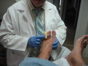 Foot Doctor treating a toe from a diabetes patient.